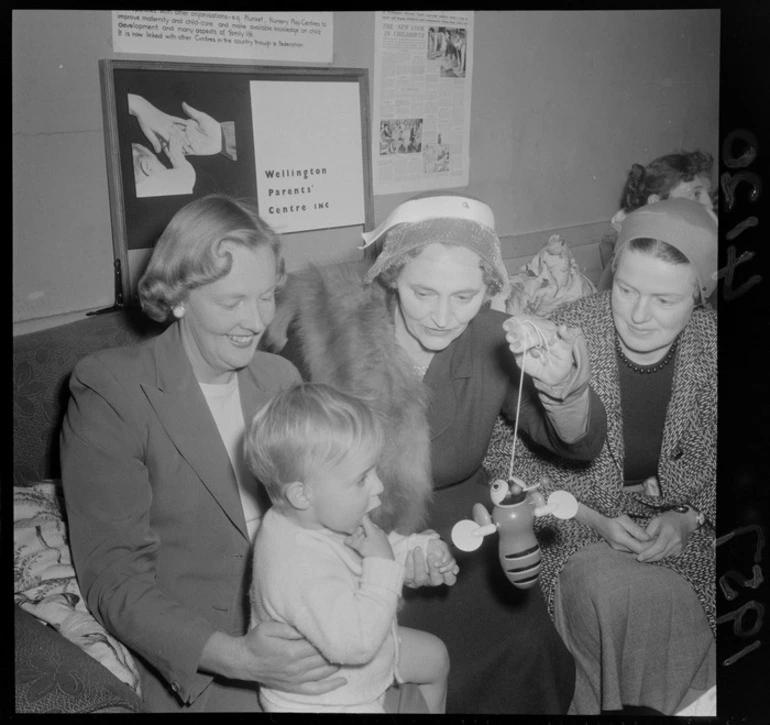 Image: Mrs Iris Kitts, Mayoress of Wellington, with two unidentified women and a baby and holding a buzzy bee, at the Wellington Parents' Centre