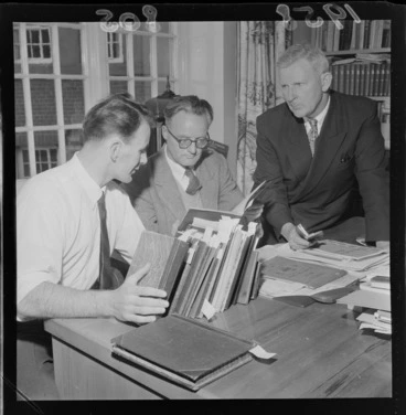 Image: Manuscripts curator, Glen Barclay, Professor Ian Gordon and Chief Librarian, Mr C R H Taylor, looking at the journals of Katherine Mansfield, which have just arrived at the Alexander Turnbull Library, Wellington
