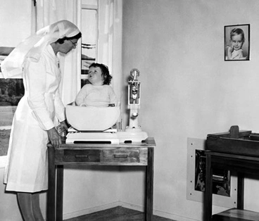 Image: Plunket nurse weighing a baby