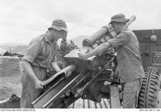 Image: South Vietnam. 1968-09-03. Gunner Murray Hall of Albany, WA (left), loads a round into the breech of one of the 105mm Howitzer guns of the 104th Field Battery, Royal Australian Artillery (RAA) ..