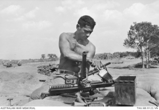 Image: Bien Hoa Province, South Vietnam. 1968-02. Using a paint brush to remove the grime from his M60 machine gun during Operation Coburg is Gunner Taawhi Kerehona of Hamilton, NZ. He is a member of the ..