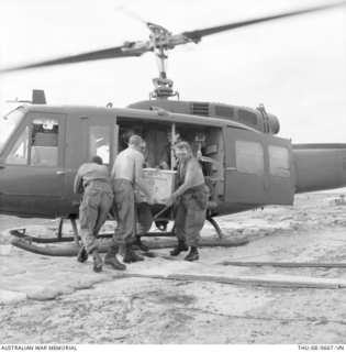 Image: BIEN HOA PROVINCE, SOUTH VIETNAM, 1968-06. A RESUPPLY HELICOPTER IS BEING UNLOADED AT FIRE SUPPORT BASE (FSB) CONCORD IN NORTHERN BIEN HOA PROVINCE SHORTLY AFTER THE BASE HAD BEEN SET UP BY 4RAR ..