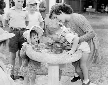 Image: Children drinking from a water fountain, 1951