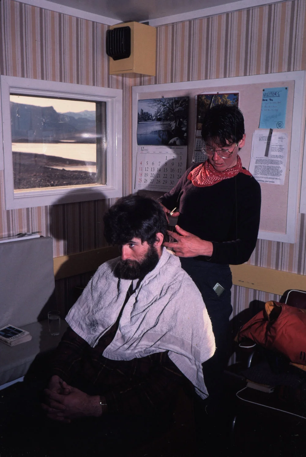 Malcolm Macfarlane getting haircut from Japanese Scientist