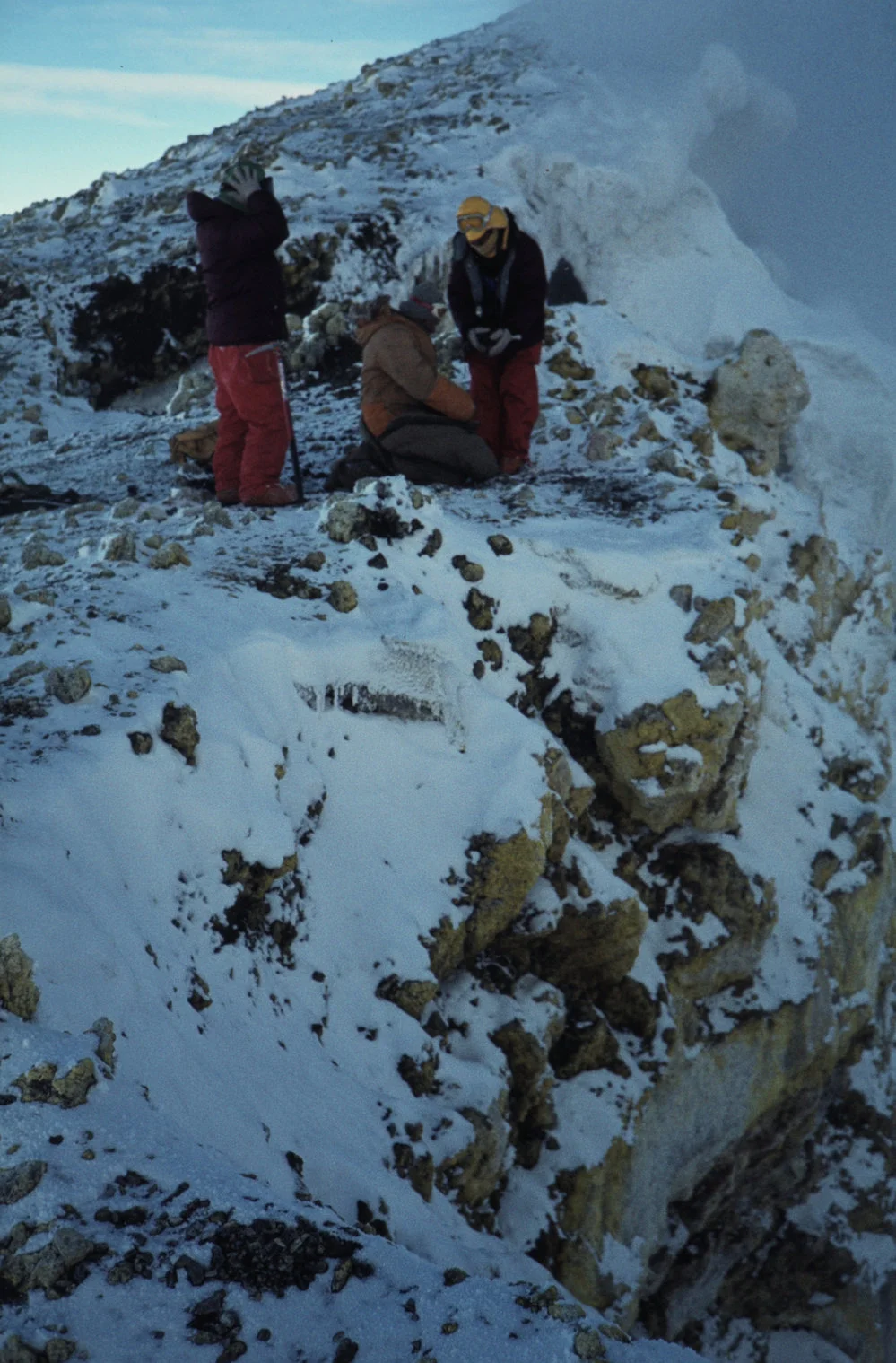 Ray Dibble getting into sleeping bag to watch activity on crater rim