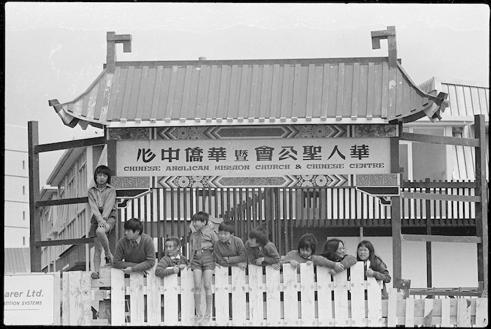 Group alongside the Chinese Anglican Mission gate, temporarily located at St Marks School, Wellington