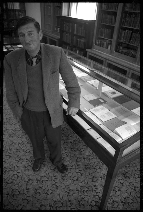 Denis Glover, founder of Caxton Press, with Book Week display in Alexander Turnbull Library