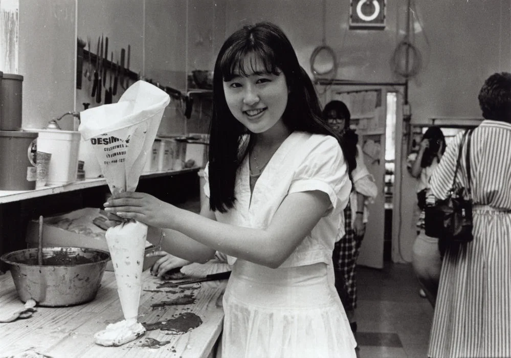Japanese visitor Mariko Hata learning how to make a chocolate eclair at Buttercup Bakery.