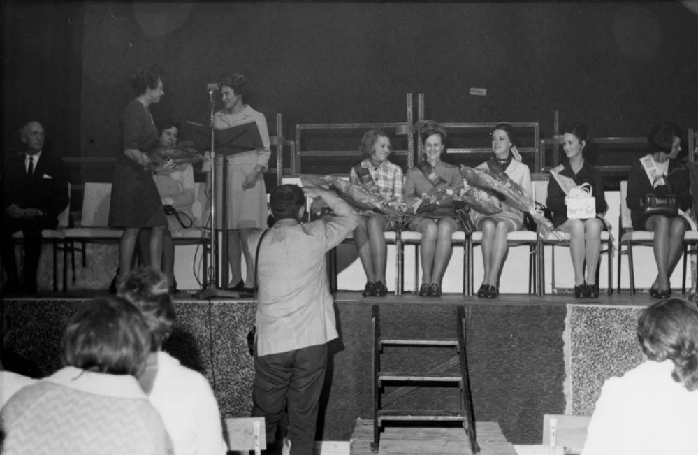 Eastern District District Pastoral Queen winner and runners-up sitting holding bouquets.