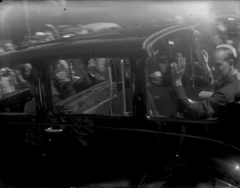 Royal Tour. Queen Elizabeth II and Prince Phillip, Duke of Edinburgh, Wave From an Open Car.