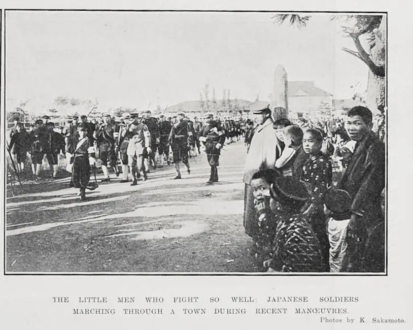 The little men who fight so well. Japanese soldiers marching through a town during recent manoeuvres