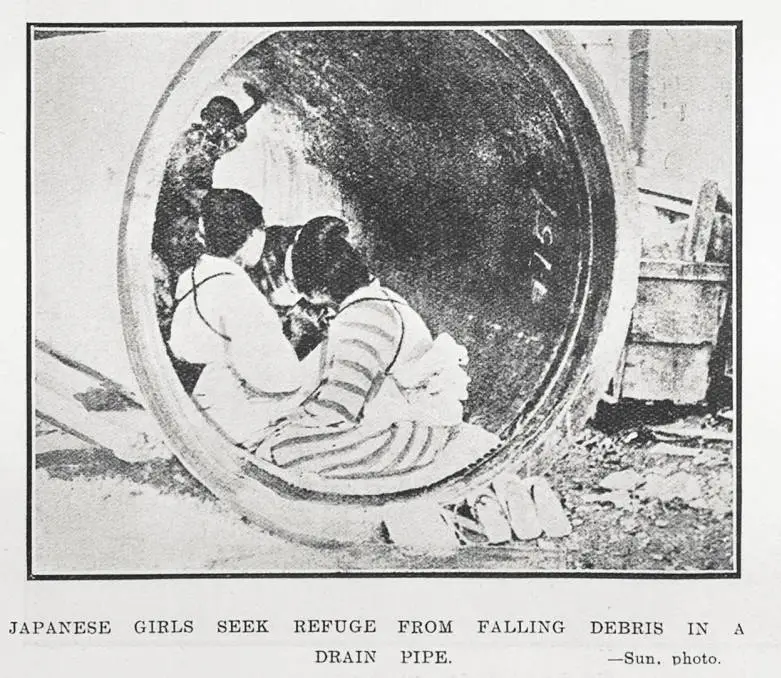 Japanese Girls Seek Refuge From Falling Debris in a Drain Pipe