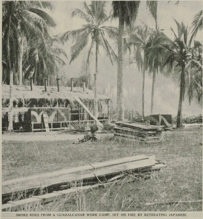 Smoke rises from a Guadalcanal work camp, set on fire by retreating Japanese