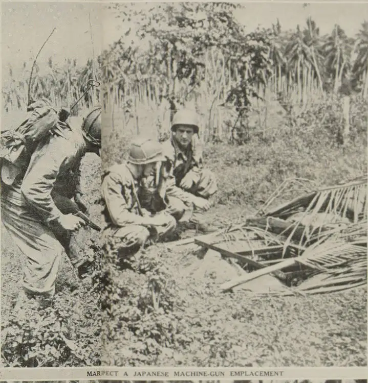 Marines inspect a Japanese machine-gun emplacement