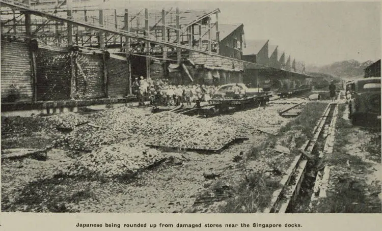 Japanese being rounded up from damaged stores near the Singapore docks