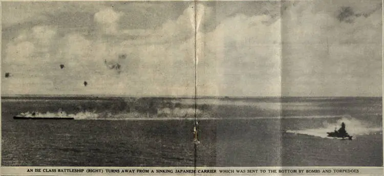 An Ise class battleship (right) turns away from a sinking Japanese carrier which was sent to the bottom by bombs and torpedoes