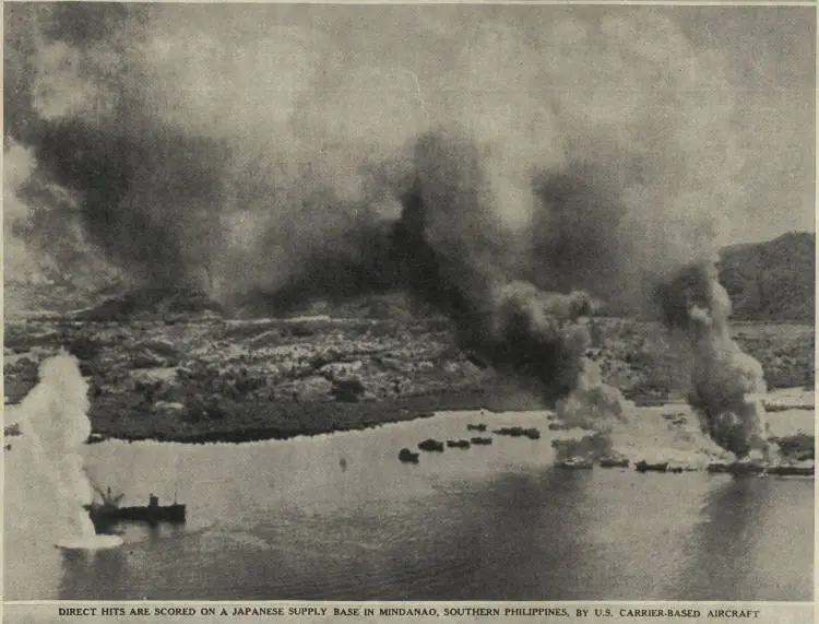 Direct hits are scored on a Japanese supply base in Mindanao, southern Philippines, by U.S. carrier-based aircraft