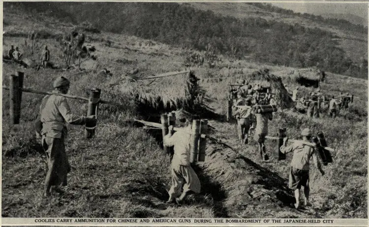 Coolies carry ammunition for Chinese and American guns during the bombardment of the Japanese-held city