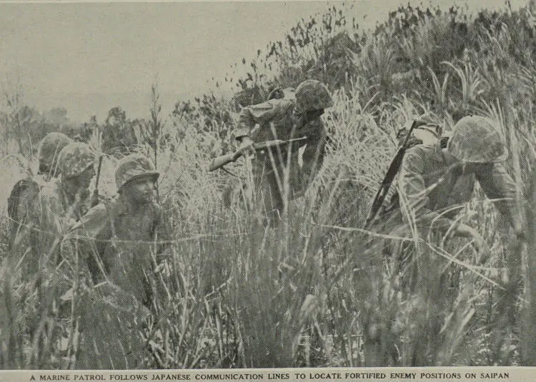 A Marine patrol follows Japanese communication lines to locate fortified enemy positions on Saipan