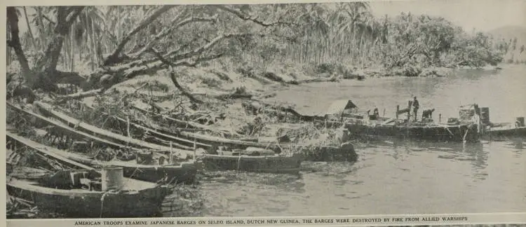 American troops examine Japanese barges on Seleo Island, Dutch New Guinea