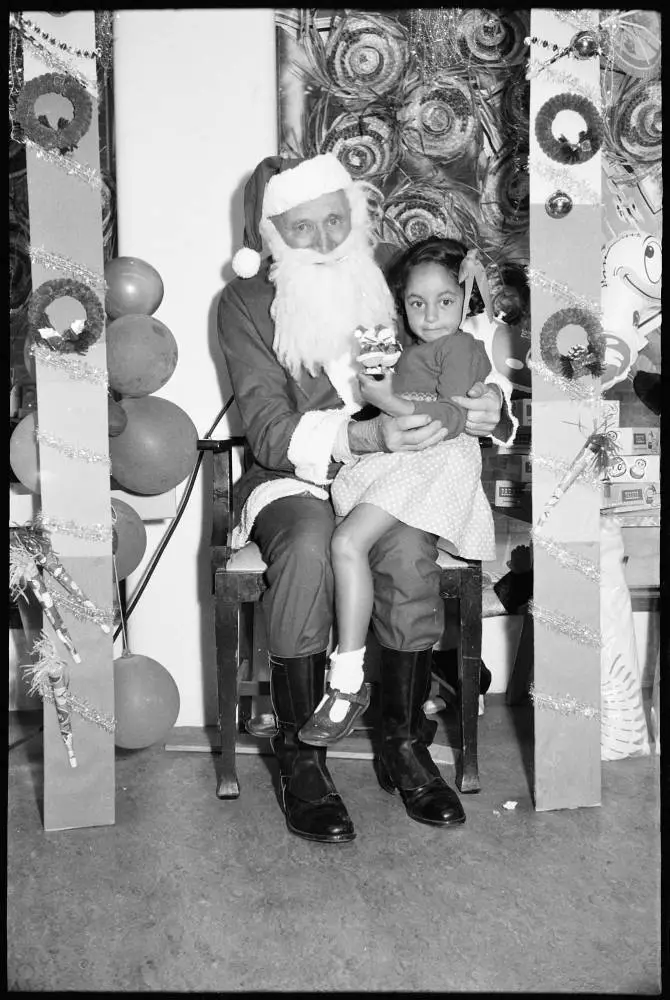 Children sitting on Santa's knee, 1959