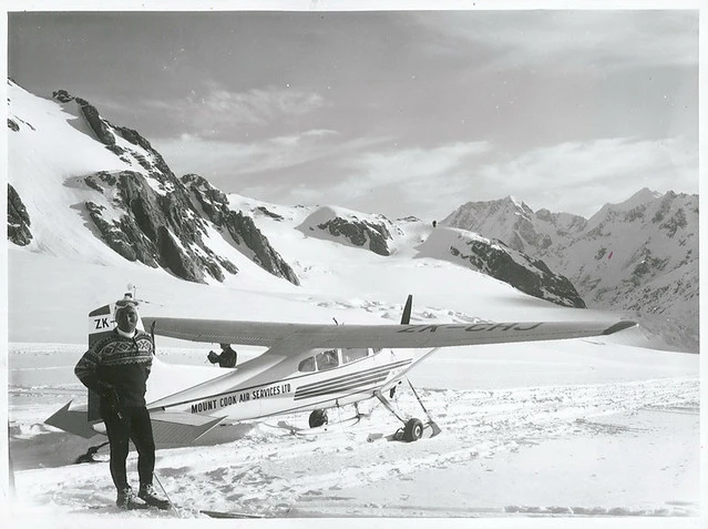 Yuichiro Miura Japan's top skier and ski instructor relaxes in front of a Mt. Cook Air Services Cessna 185 at the head of the Tasman Glacier. Mt. Cook.