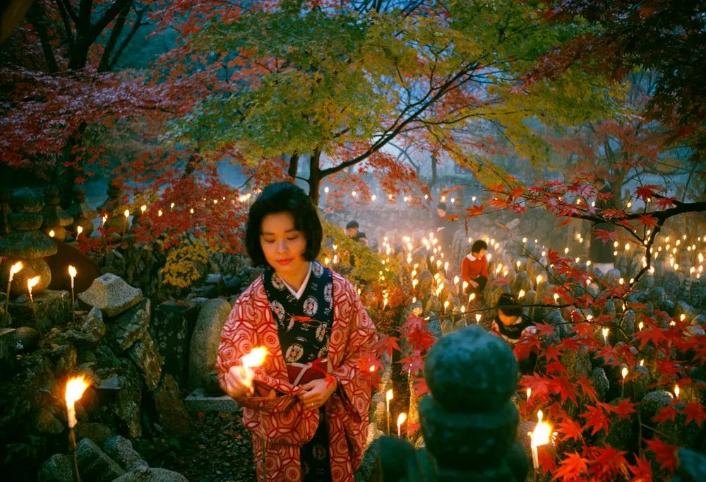 'Offerings to the unknown dead, Kyoto' [Toshi Satow offering a candle]. Taken for a series on Japan for 'Life'