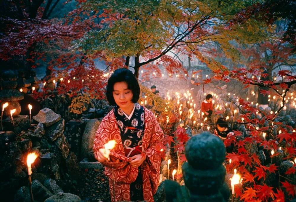 'Offerings to the unknown dead, Kyoto' [Toshi Satow offering a candle]. Taken for a series on Japan for 'Life'