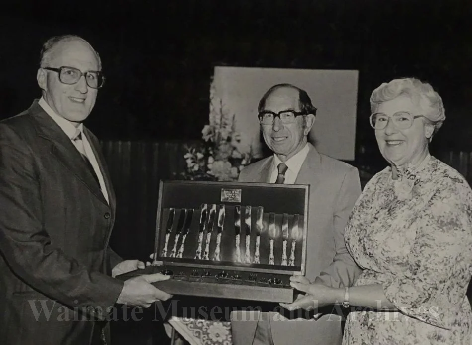 P Collins presenting Andrew and Doreen McLay with cutlery set