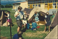 Children and teacher erecting tents