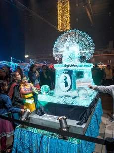 Children marvel at the ice sculpture at the Diwali Festival