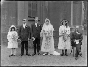 Unidentified wedding group, showing bride, bridegroom, bridesmaid, flowergirl and two other unidentified men, outside St Paul's Presbyterian Church, Christchurch