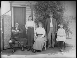 Unidentified family group, in front of a wooden domestic building, probably Christchurch district
