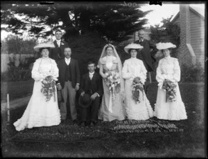 Unidentified wedding group, showing bride and groom, groomsmen, bridesmaids and [father of the bride?], probably Christchurch district