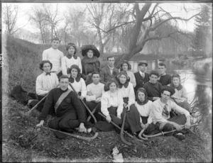 Unidentified group including a hockey team and others, possibly students, probably by the Avon River, Christchurch
