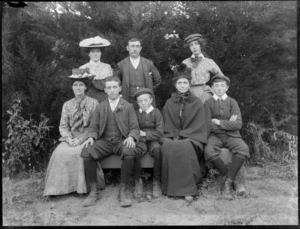 Unidentified group of elderly woman with three younger women, a man and three boys, in front of trees, probably Christchurch region