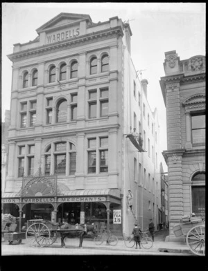 Wardells Merchants store building Christchurch, with horse & cart, boy with bike in front, painters on scaffolding and ladder in side alley, with Brian & Small Dentists and N Z Bicycle & Key Registration Association on higher floors