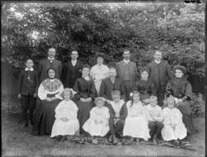Unidentified family group outdoors, showing men, women and children, probably Christchurch district