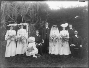 Unidentified wedding group outdoors, showing bride and groom, groomsmen, bridesmaids, flowergirl and [father of bride?], probably Christchurch district