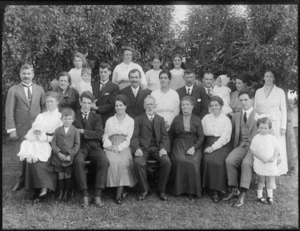 Members of an unidentified family in a group portrait, taken in an unidentified park under the trees, probably Christchurch district