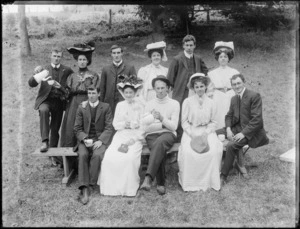 Group of unidentified men and women, some holding teacups or serving tea, in an outdoor location, possibly Christchurch district