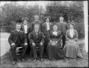 Members of an unidentified family, showing two men and two women sitting on chairs and two men and two women standing at the back, in the garden, probably Christchurch district