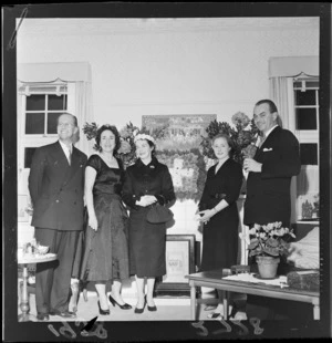 Unidentified group at Swiss reception, standing in front of Swiss flag floral arrangement
