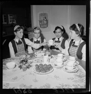 Students at Wellington East Girls' College, with cakes and tea that they have made in a Home Economics class