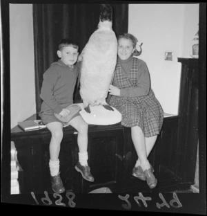 Russian children pose with a stuffed penguin at the Russian Embassy, Wellington