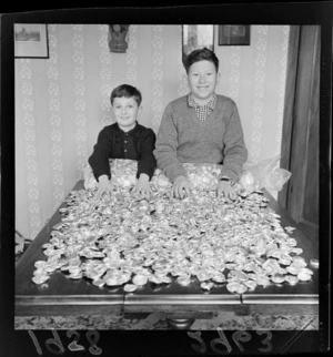 Two unidentified boys with a large collection of milk bottle tops