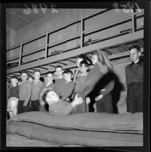 Boys lined up waiting for a turn to jump on the mat at the holiday 'camp' at the Wellington Boys Institute