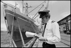 Port agriculture officer Neill Young beside the British freighter Illyric