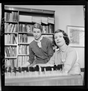 Two unidentified librarians in the library at the United Kingdom High Commission