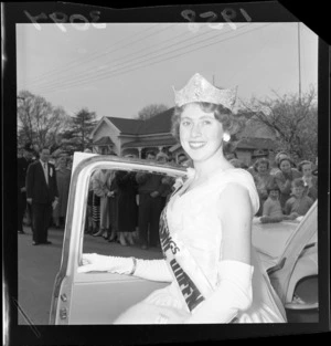 Miss Hastings Blossom Festival standing beside a car
